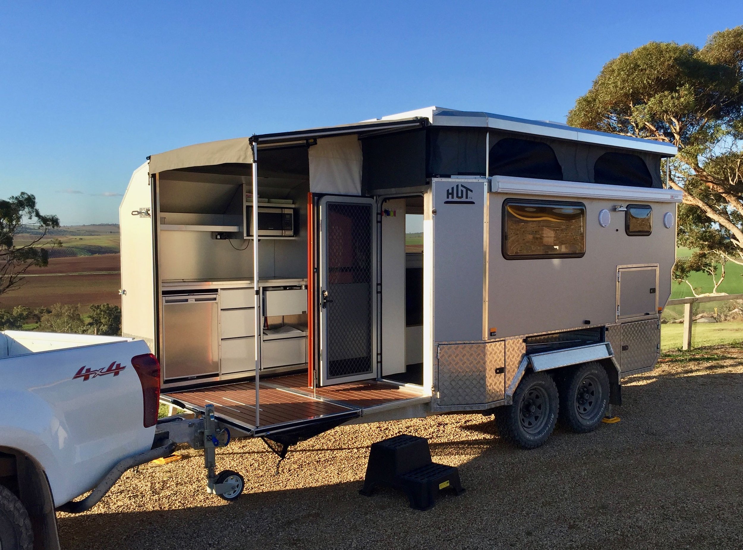 The DEKPOD expanding feature of the HUTrv prototype completely set up into a deck, kitchen and bathroom.
